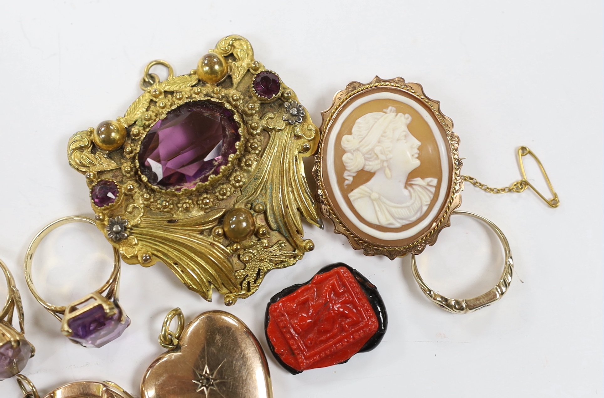 Three assorted 9ct gold and gem set rings including 1960's amethyst, a 9ct and oval cameo shell set brooch, a George V 9ct gold circular locket and three other items including diamond chip set heart shaped locket.
